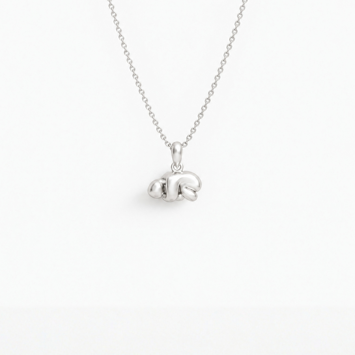 Curled-up Figure Pendant in 925 sterling silver, hanging from a fine chain