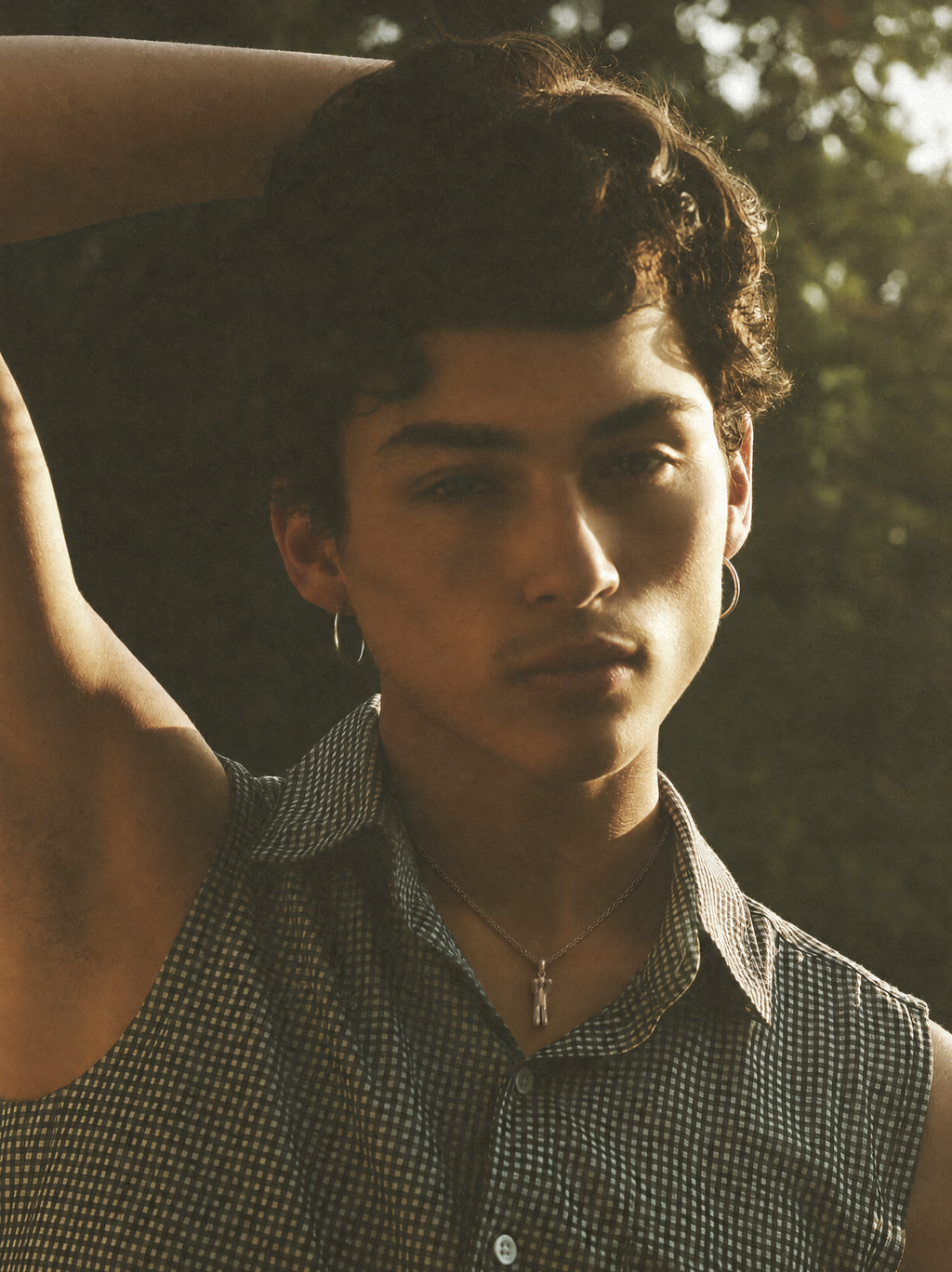 A model wearing the Leaping Figure Pendant on a fine silver chain