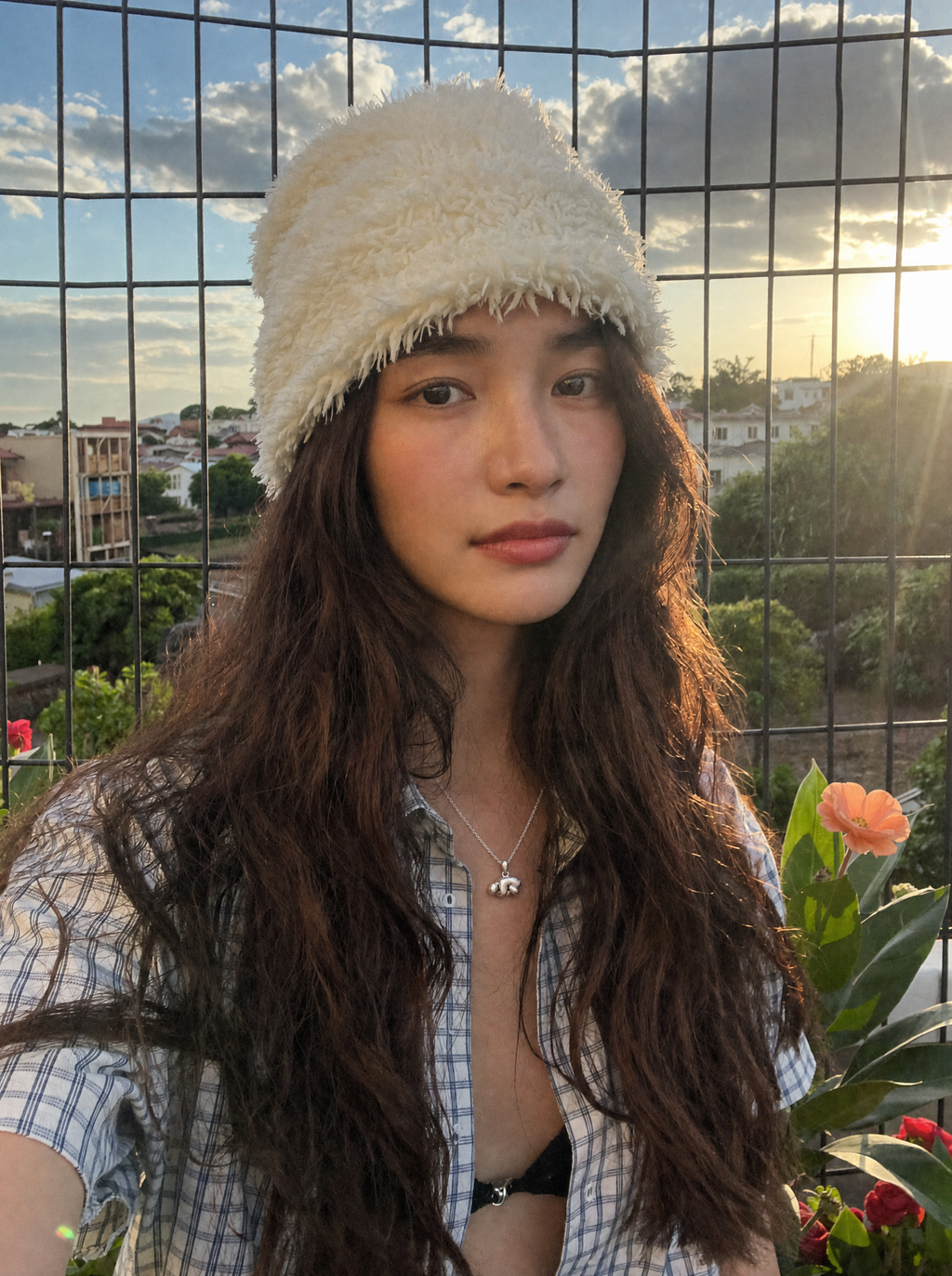A model wearing the Curled-up Figure Pendant on a fine silver chain