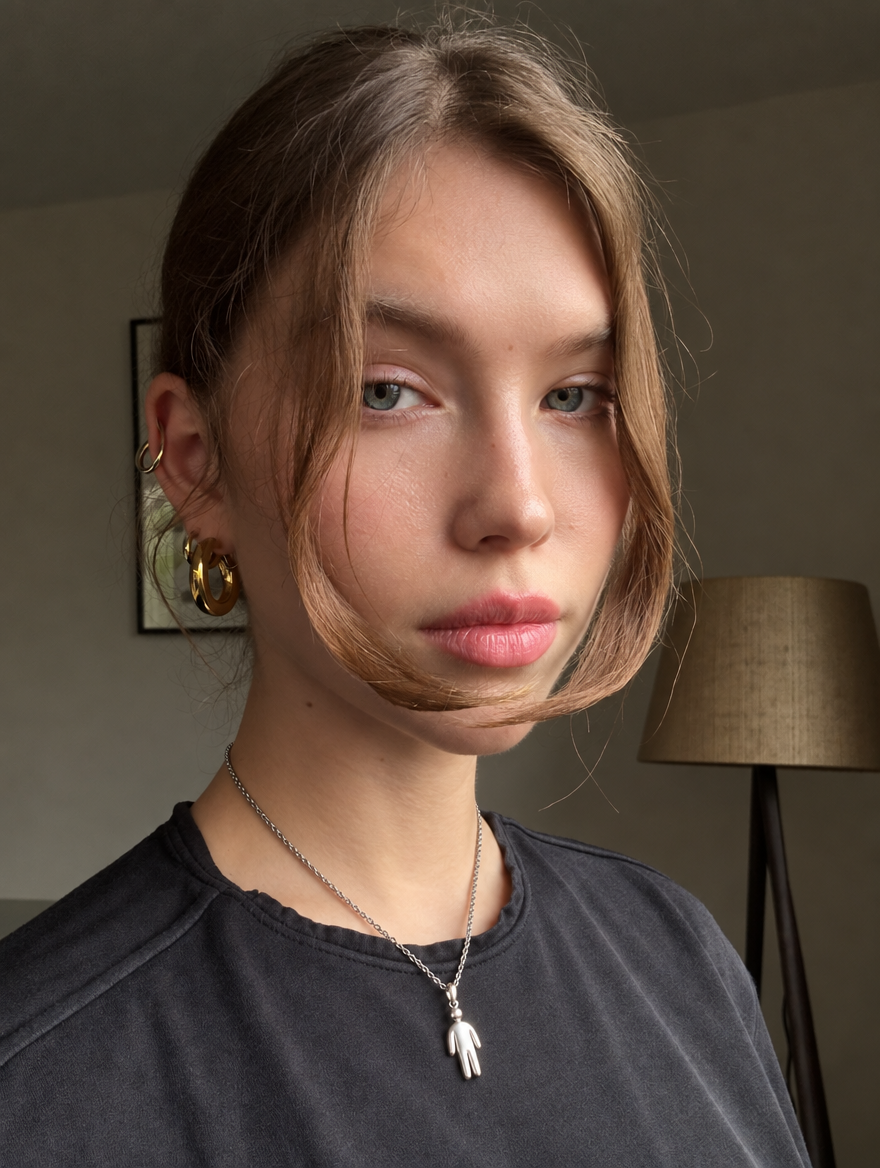 A model wearing the Human Figure Pendant on a fine silver chain