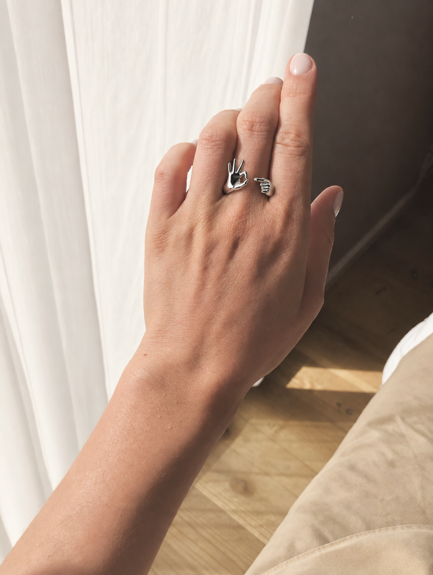 The Do You Wanna? ring worn on the hand